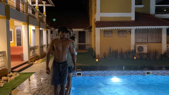 Vaibhav at the edge of a pool at night, about to jump in