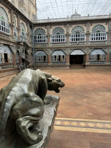 A bronze panther statue in a palace courtyard